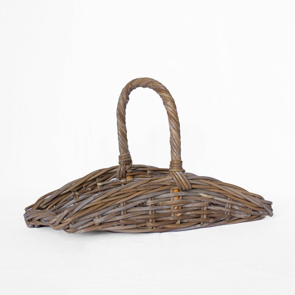 Wicker basket with handle on a white background