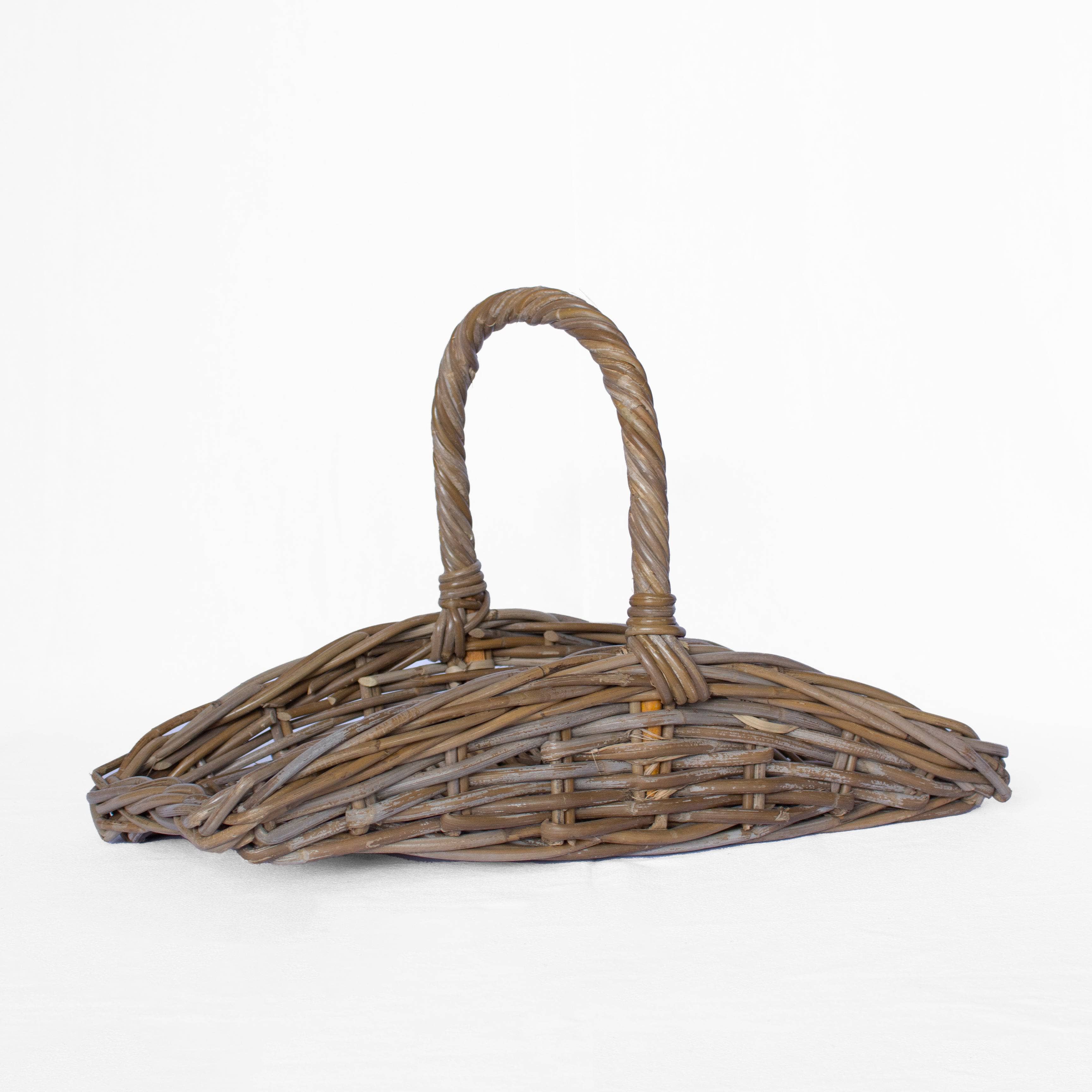 Wicker basket with handle on a white background
